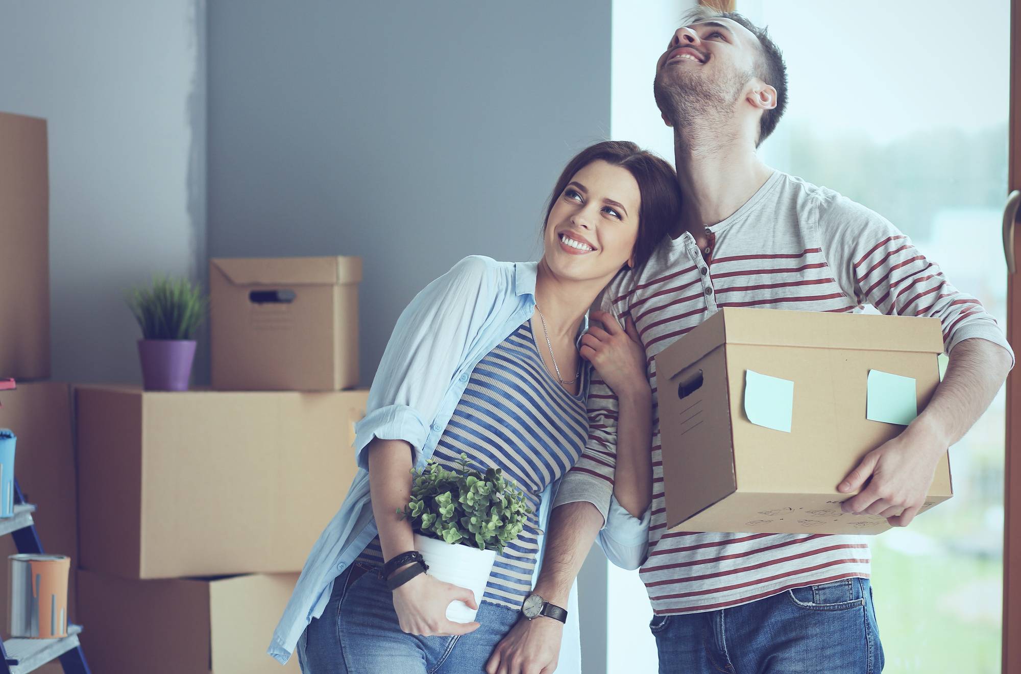 Happy young couple unpacking o