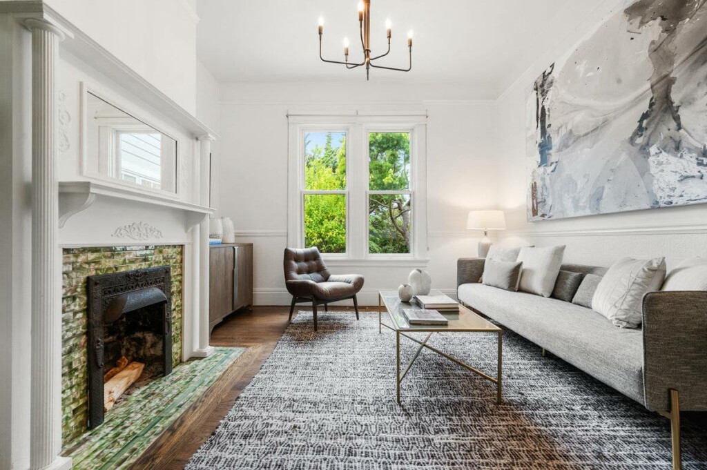 The living room in 138 27th St with a fireplace and chandelier, where we helped to sell a condo in Noe Valley