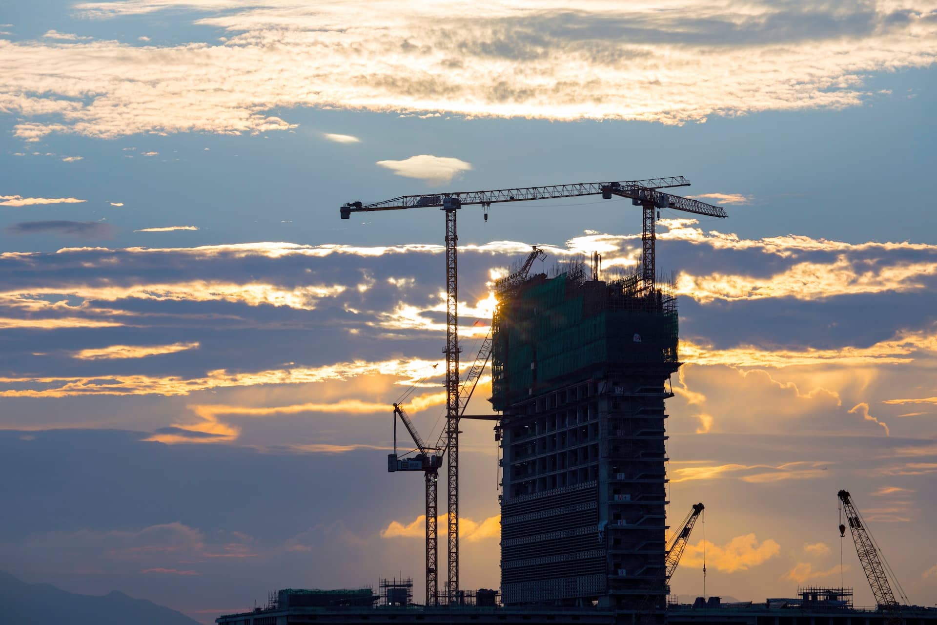 A new construction condo building being built by cranes in San Francisco, where we recommend you use a Realtor buyer's agent for best results!