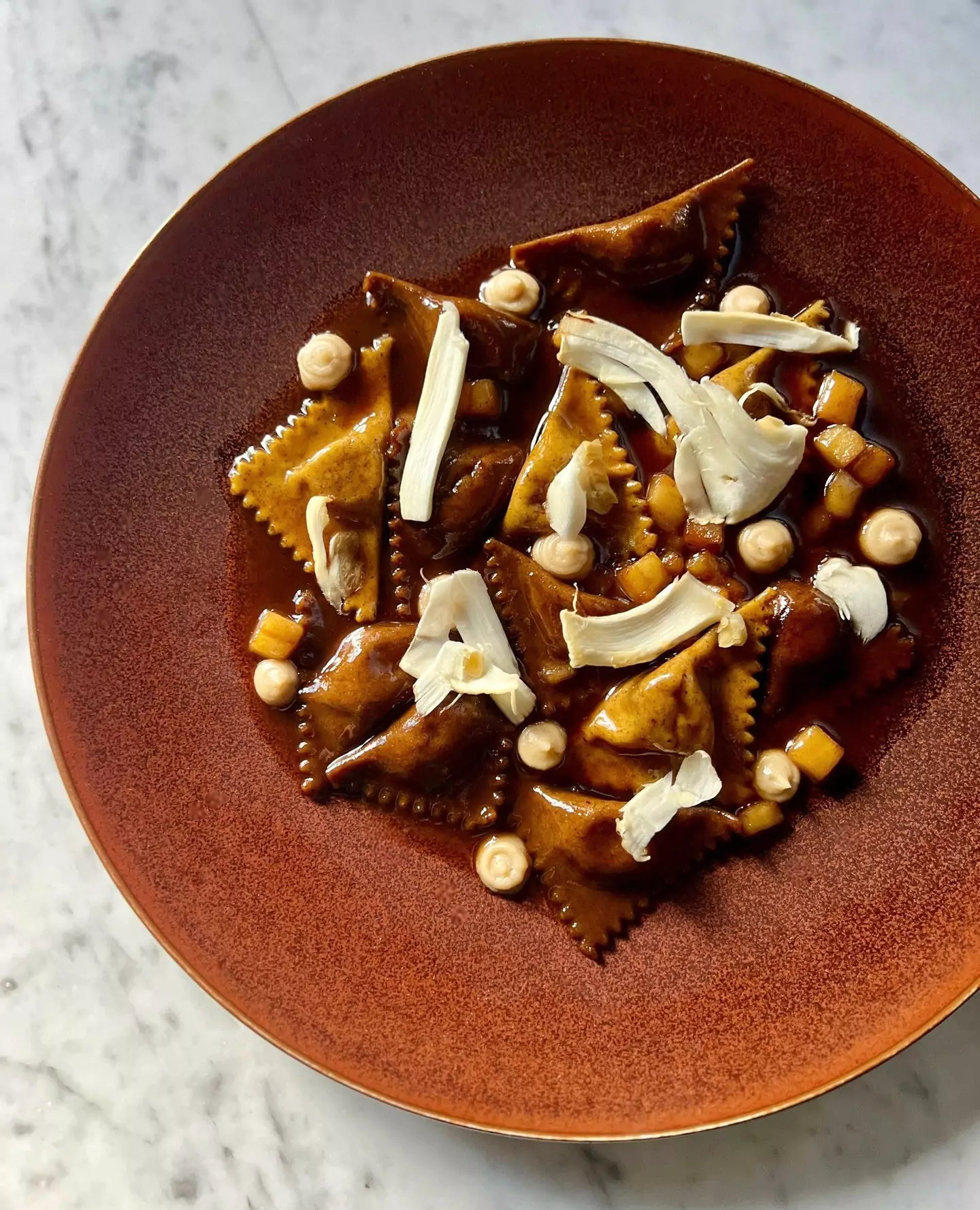 Chestnut ravioli with matsutake, apple, brown butter sauce, and rosemary from modern Italian restaurant Flour + Water in San Francisco