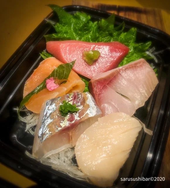 Four Kinds of Sushi on Black Tray at Saru