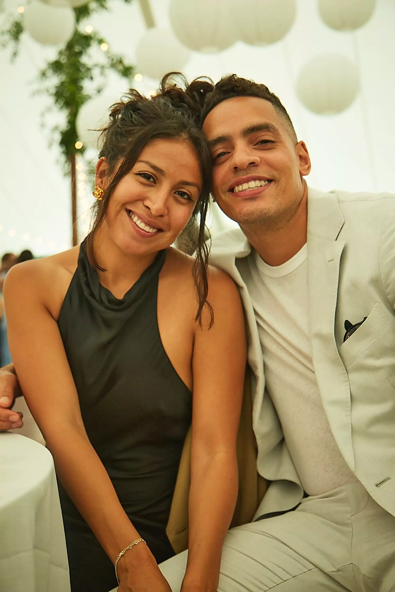 A smiling man and woman sitting at a table, Happy House buyers in San Francisco.