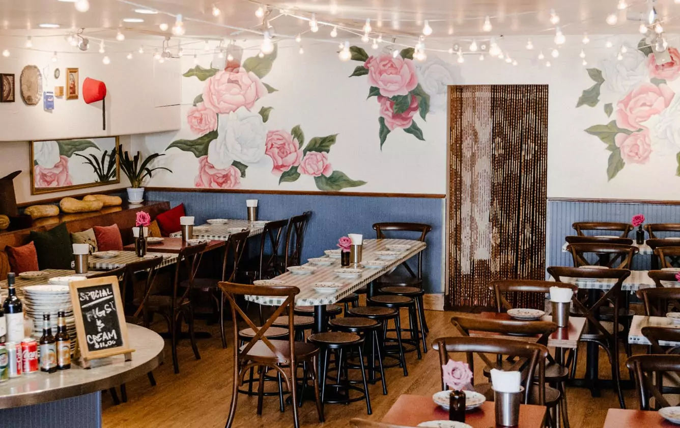 Cozy, Inviting Atmosphere, Communal Dining, and Flower Mural on Wall at Arabic Restaurant Beit Rima