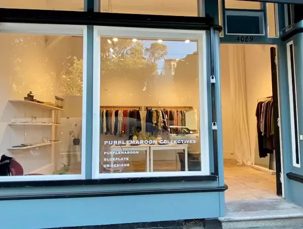 View of PurpleMaroon Shop from Sidewalk with Large Window and Clothing