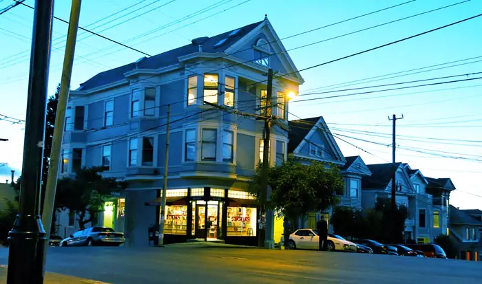 Street view at dusk of Christopher’s Books lit up inside